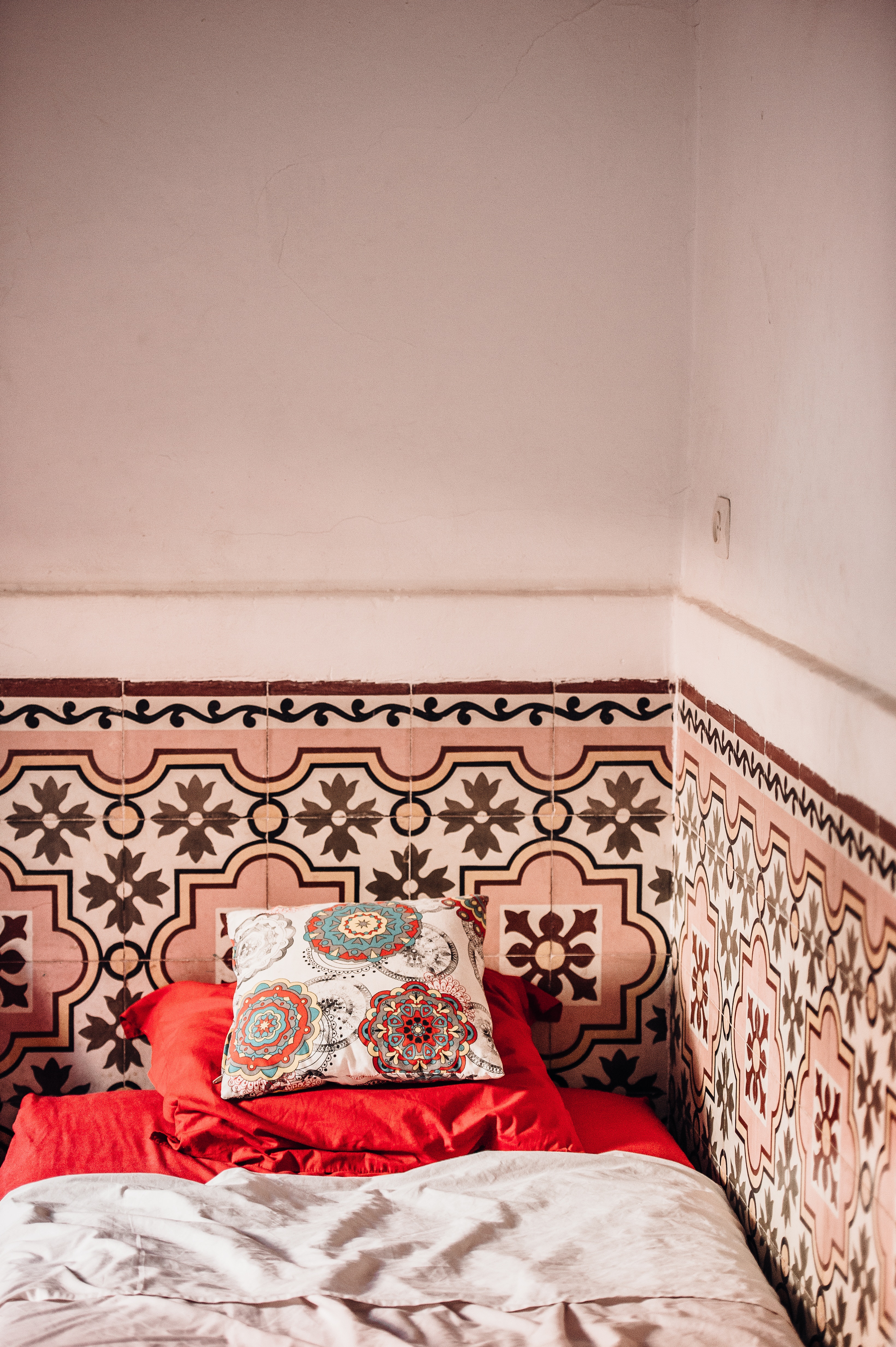 Tiled bedroom wall behind bed