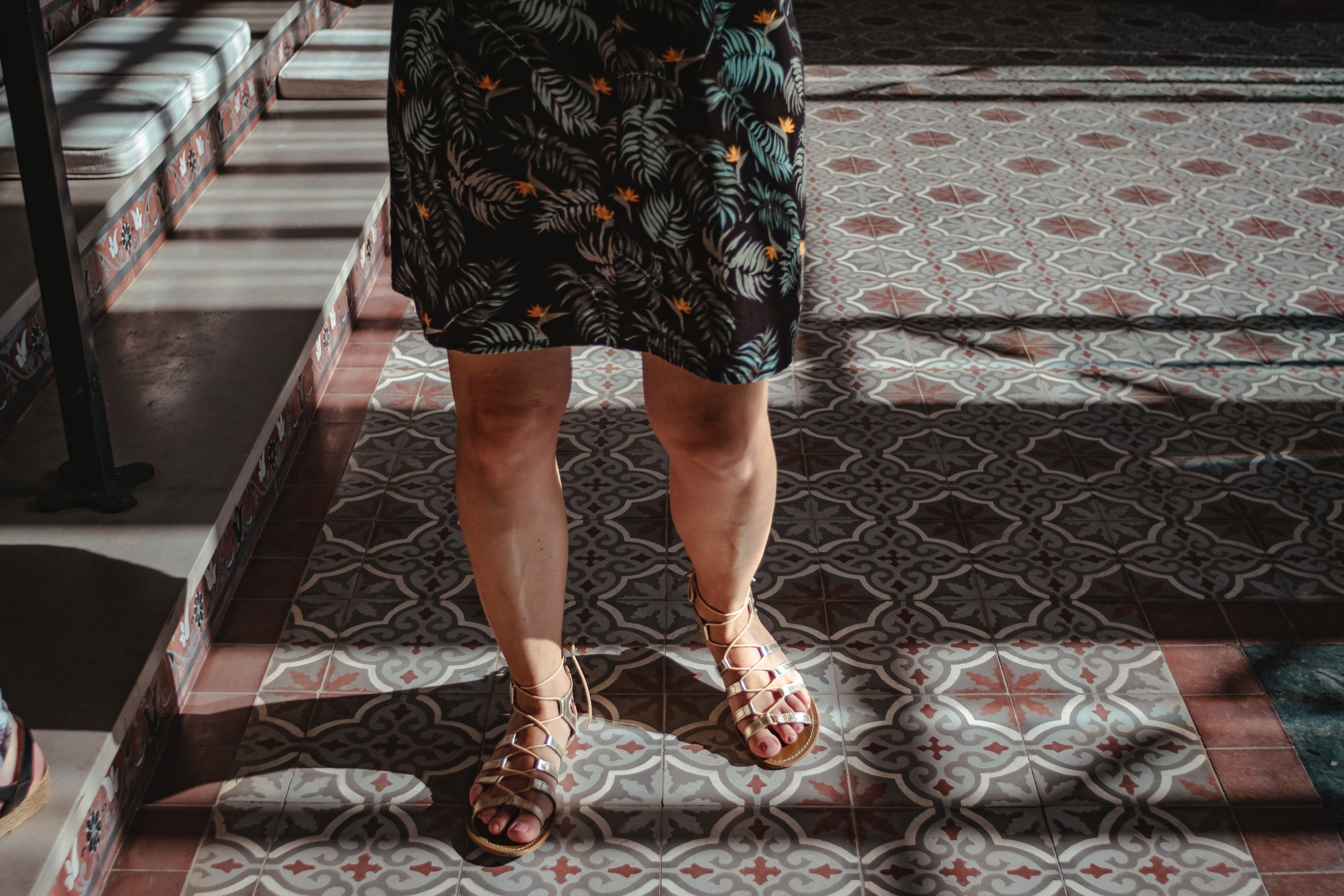 Woman standing on patterned floor tiles
