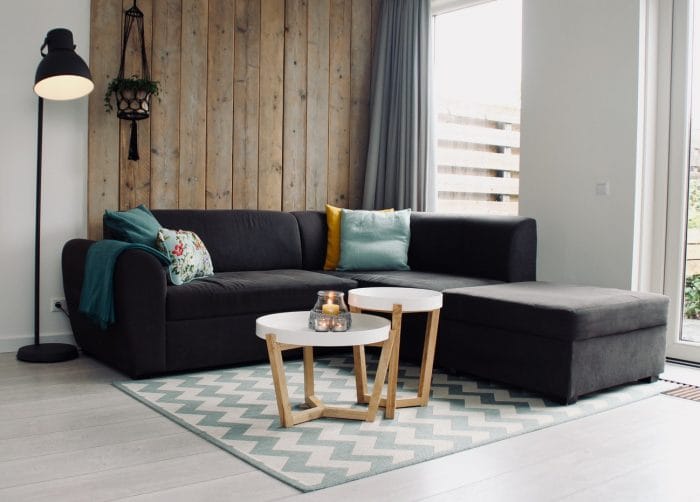 Grey sofa with coffee table and rug