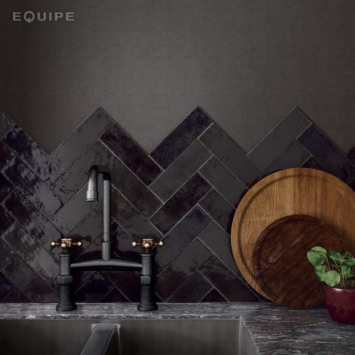 black kitchen wall tiles and tap